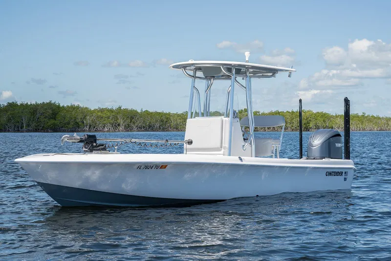 Slide: The Image of 2024 Contender 26 Bay boat on calm water, clear sky background. - 4