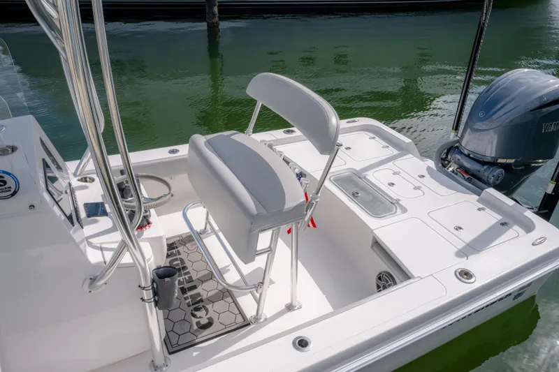 Slide: The Image of 2024 Contender 26 Bay boat interior with seating and Yamaha outboard motor. - 6