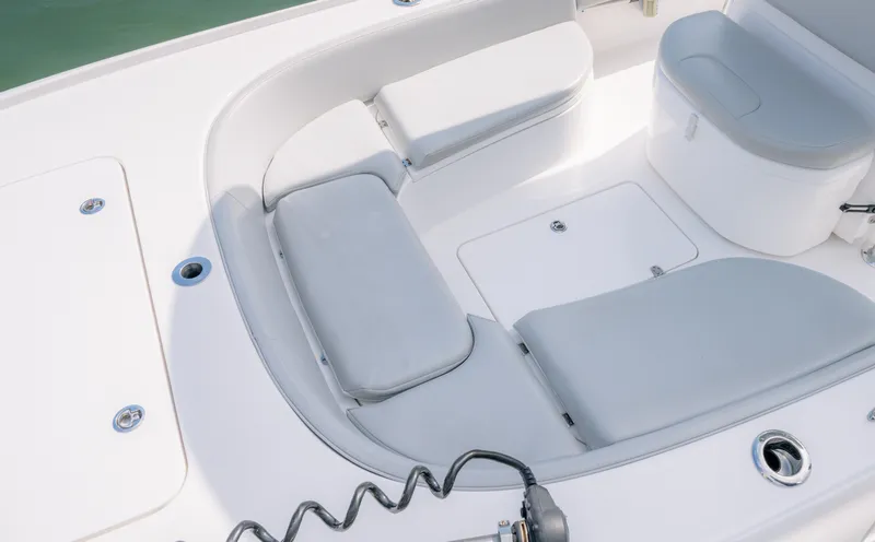 Slide: The Image of 2024 Contender 26 Bay boat interior with cushioned seating and storage compartments. - 7