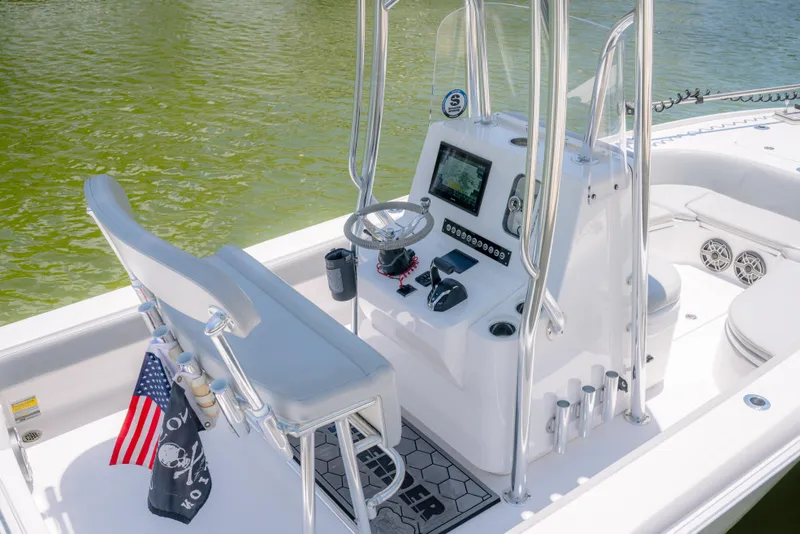 Slide: The Image of 2024 Contender 26 Bay boat interior with modern console and seating on calm water. - 9