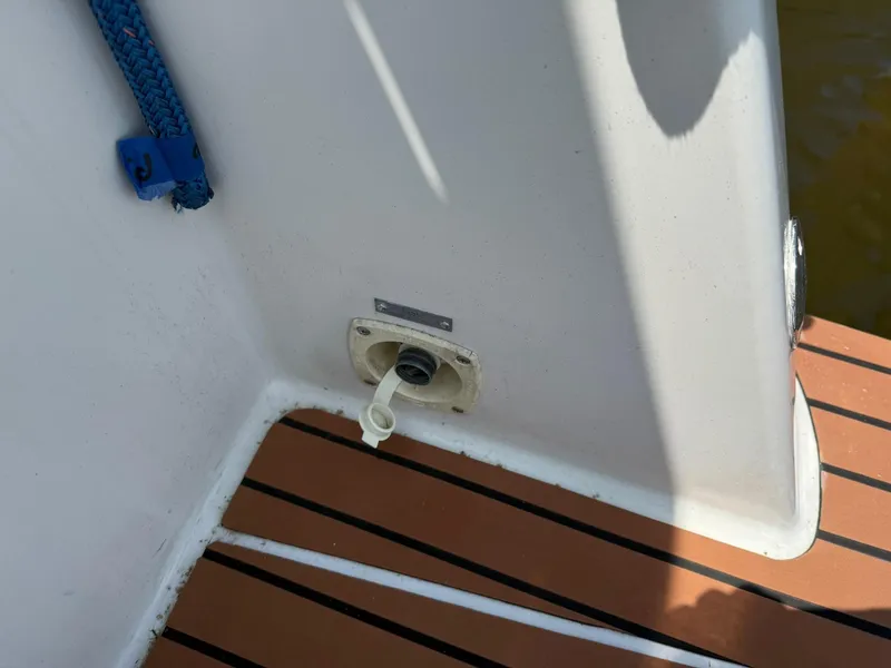 Slide: The Image of 1996 Carver 325 Aft Cabin boat deck with water inlet and blue rope. - 10