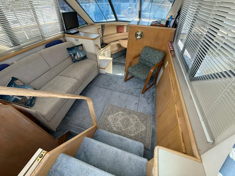 Slide: The Image of Interior of 1996 Carver 325 Aft Cabin yacht with cozy seating and modern design. - 13