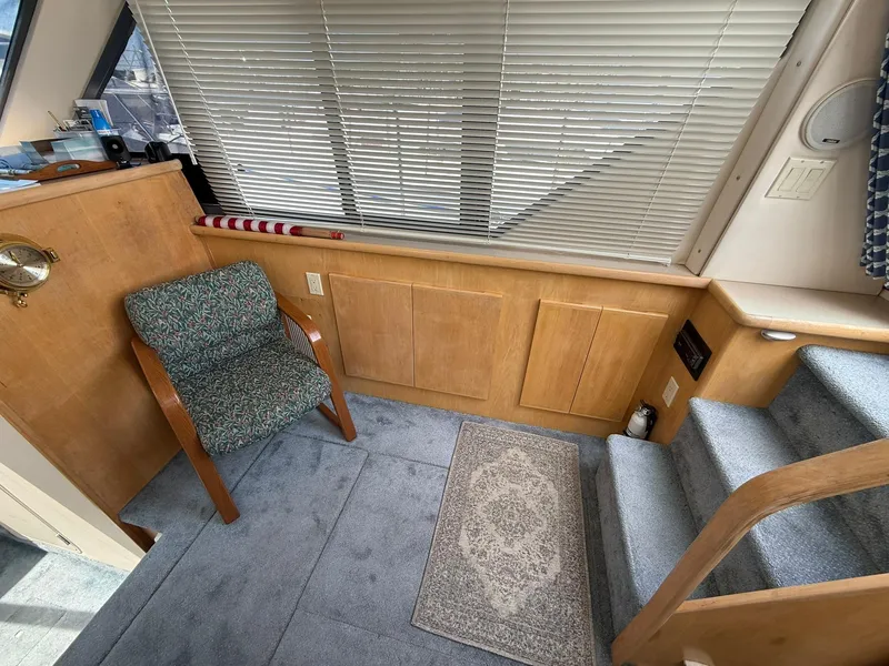 Slide: The Image of 1996 Carver 325 Aft Cabin interior with chair, carpet, and stairs. - 15