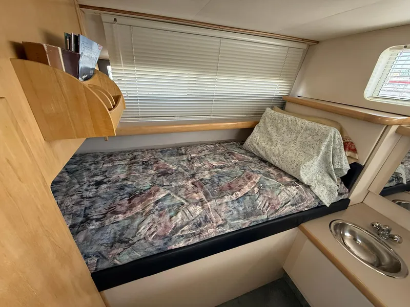 Slide: The Image of 1996 Carver 325 Aft Cabin interior with bed, sink, and window blinds. - 17