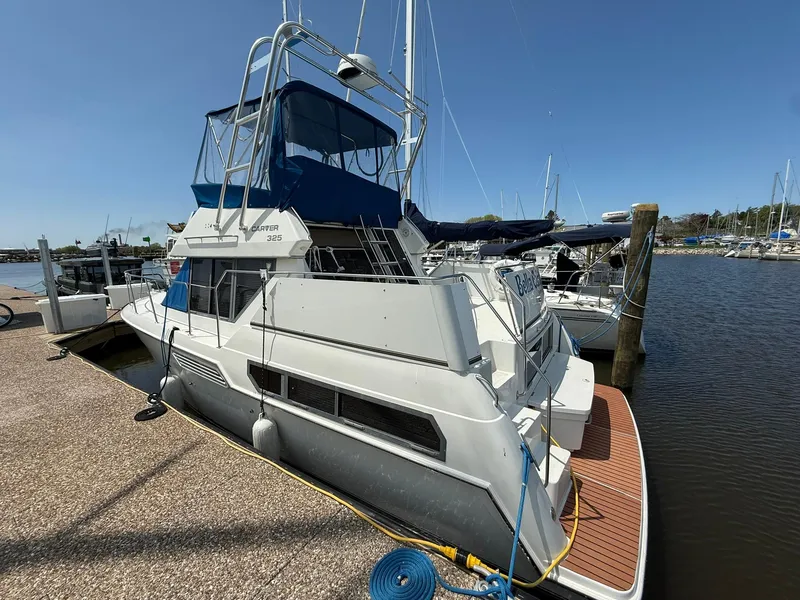 Slide: The Image of 1996 Carver 325 Aft Cabin yacht docked at marina under clear blue sky. - 2
