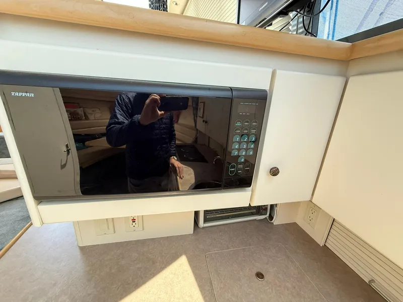 Slide: The Image of 1996 Carver 325 Aft Cabin kitchen with microwave and countertop. - 21