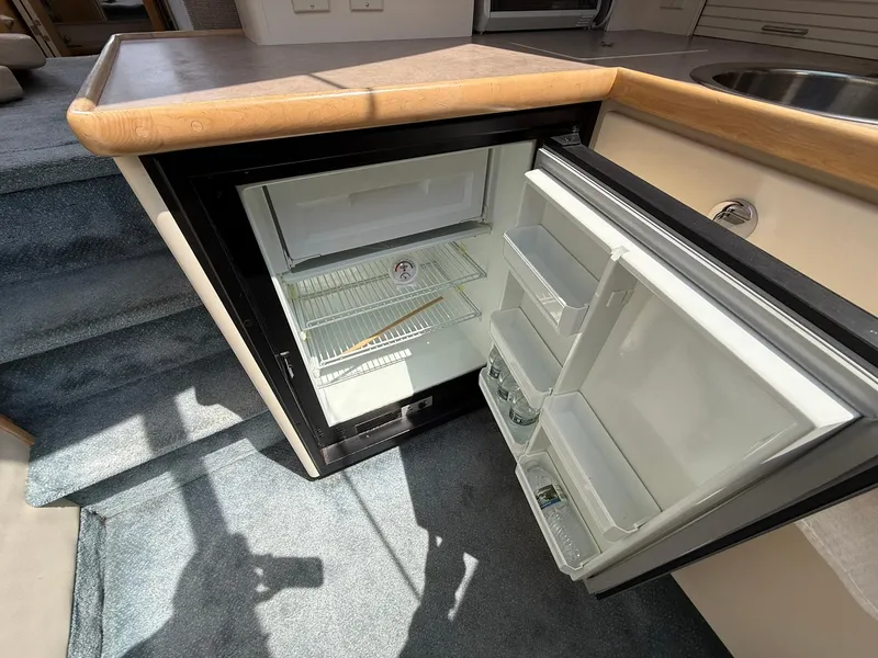 Slide: The Image of Open mini fridge in 1996 Carver 325 Aft Cabin yacht interior. - 23