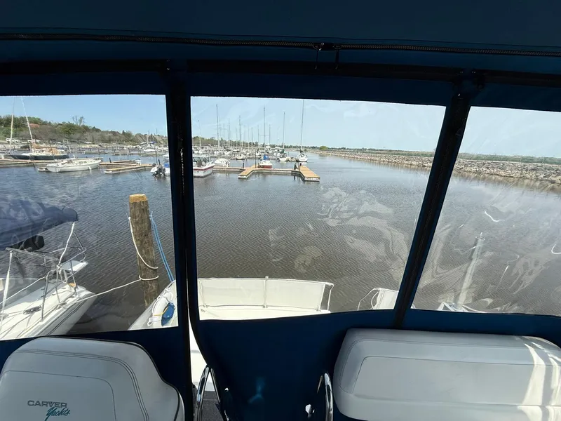 Slide: The Image of View from 1996 Carver 325 Aft Cabin, overlooking marina with docked boats. - 26