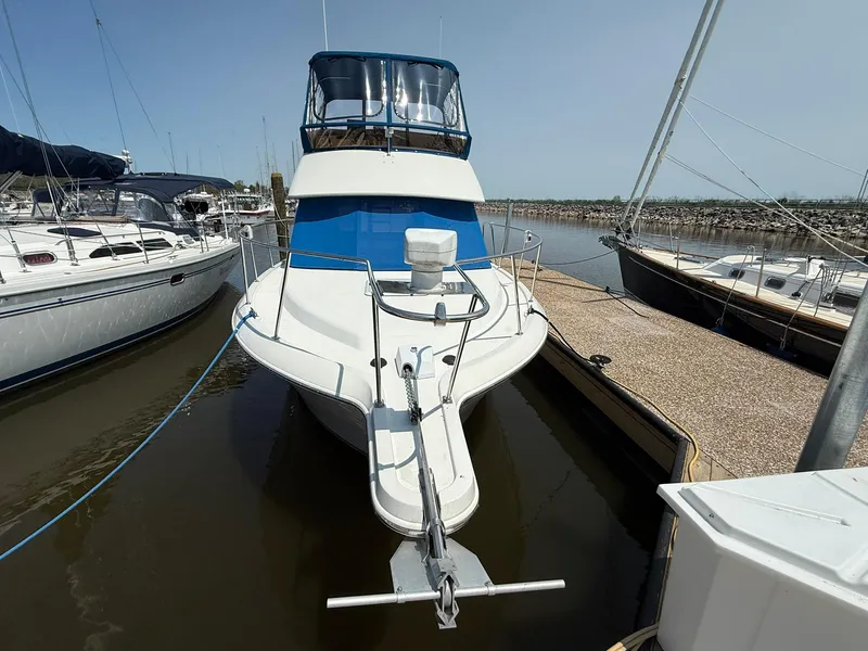 Slide: The Image of 1996 Carver 325 Aft Cabin yacht docked at marina, front view. - 3