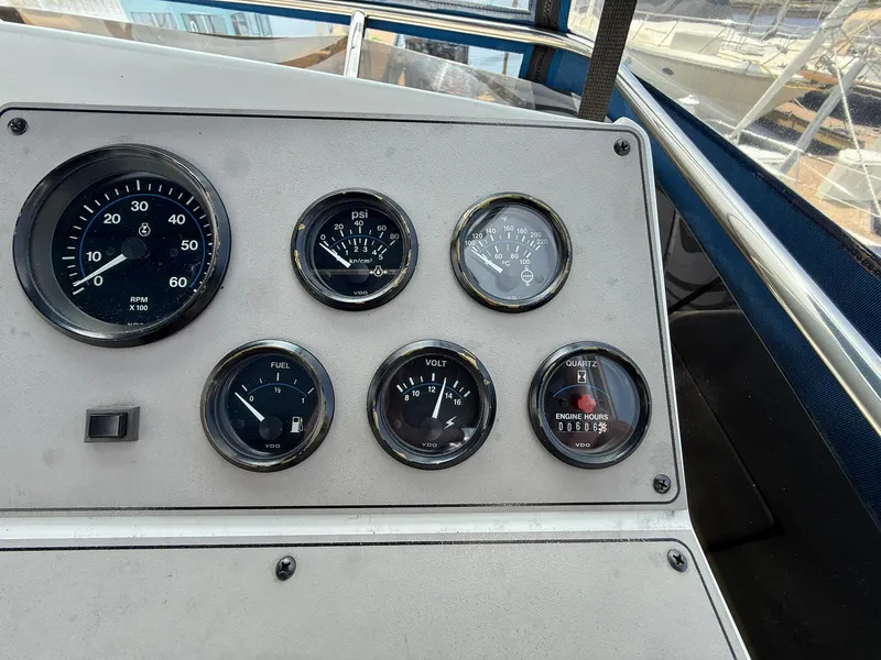 Slide: The Image of 1996 Carver 325 Aft Cabin dashboard with gauges for speed, fuel, voltage, and engine hours. - 31