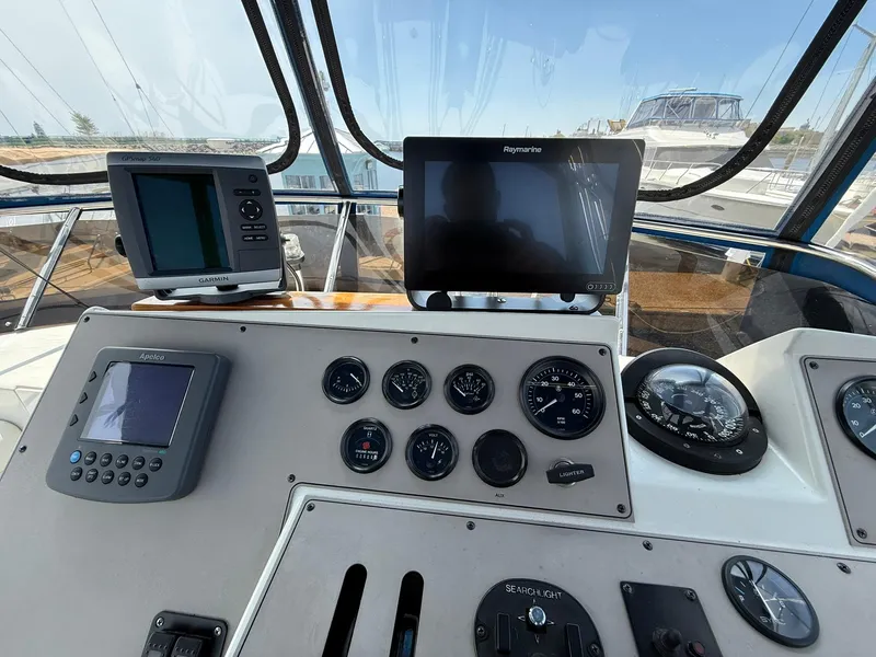 Slide: The Image of 1996 Carver 325 Aft Cabin helm with navigation instruments and gauges. - 34