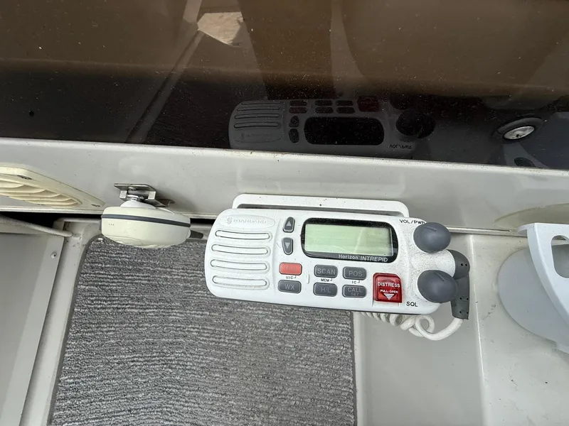Slide: The Image of 1996 Carver 325 Aft Cabin boat radio and control panel on gray carpeted surface. - 35