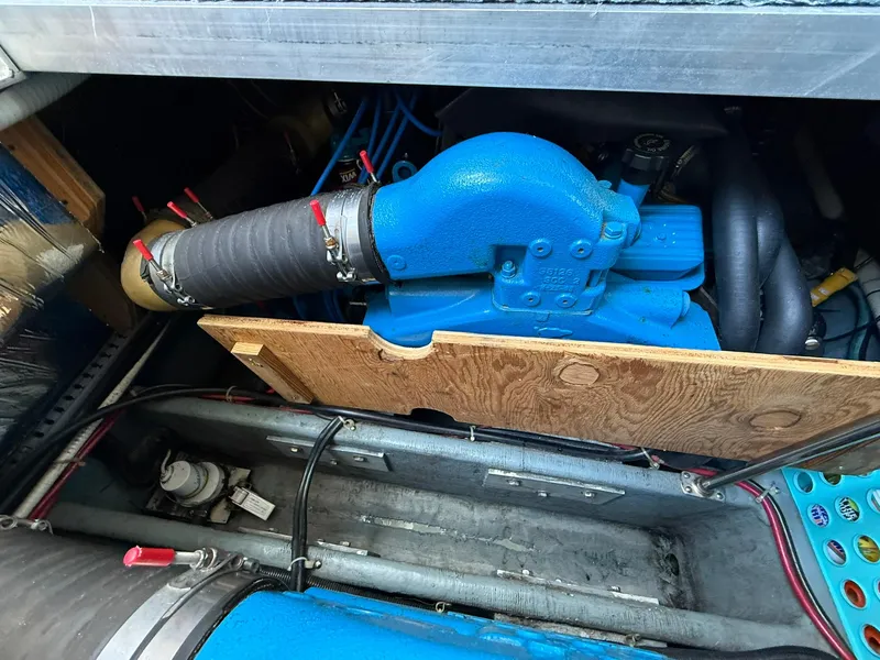 Slide: The Image of Engine compartment of a 1996 Carver 325 Aft Cabin boat, featuring blue engine components. - 36