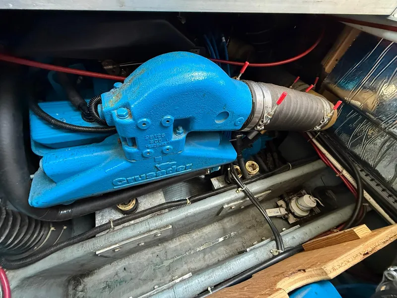 Slide: The Image of 1996 Carver 325 Aft Cabin engine compartment with blue engine components and wiring. - 37
