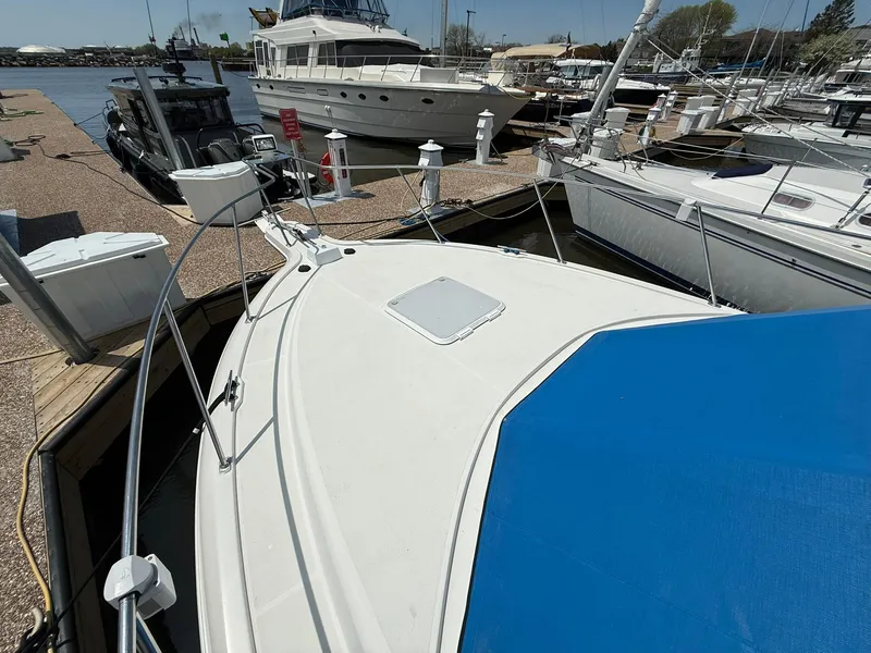 Slide: The Image of 1996 Carver 325 Aft Cabin docked at marina, surrounded by other boats. - 5