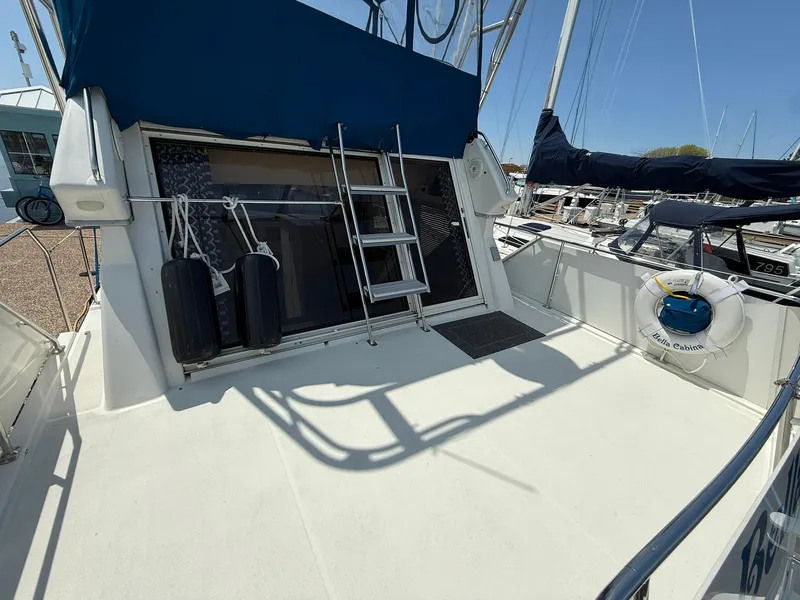 Slide: The Image of 1996 Carver 325 Aft Cabin yacht deck with ladder and safety equipment. - 8