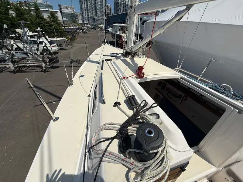 Slide: The Image of 2022 J Boats J/9 sailboat deck with rigging, docked in urban marina. - 10