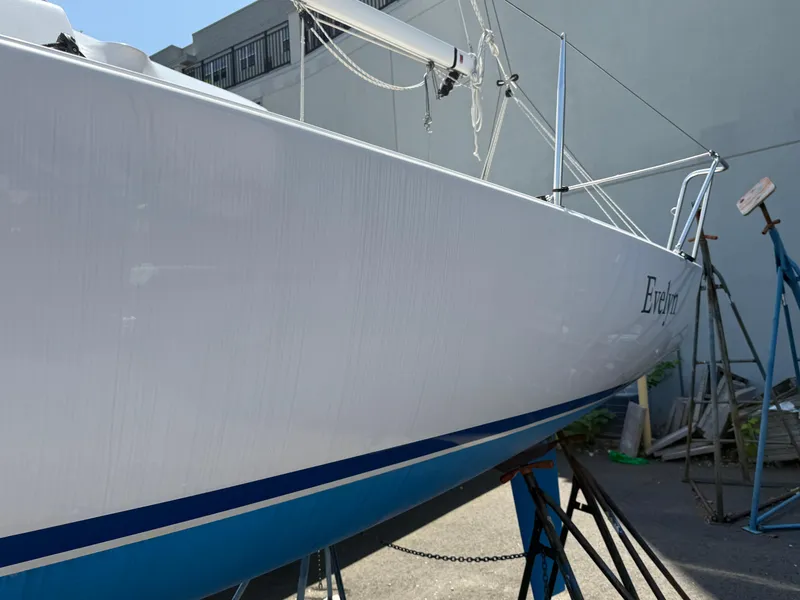 Slide: The Image of 2022 J Boats J/9 sailboat on stands, side view in a marina setting. - 13