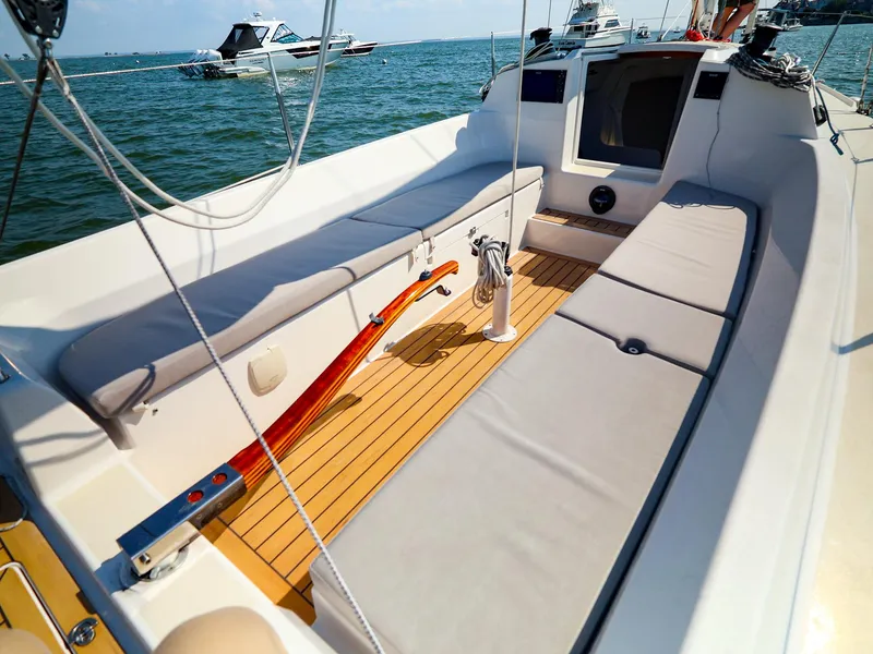 Slide: The Image of 2022 J Boats J/9 sailboat cockpit with cushioned seating and wooden deck. - 18