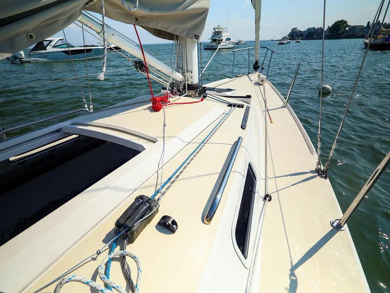 Slide: The Image of 2022 J Boats J/9 sailboat deck with ropes and fittings on calm water. - 19