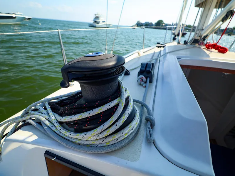 Slide: The Image of 2022 J Boats J/9 sailboat deck with winch and ropes, sailing on calm waters. - 31