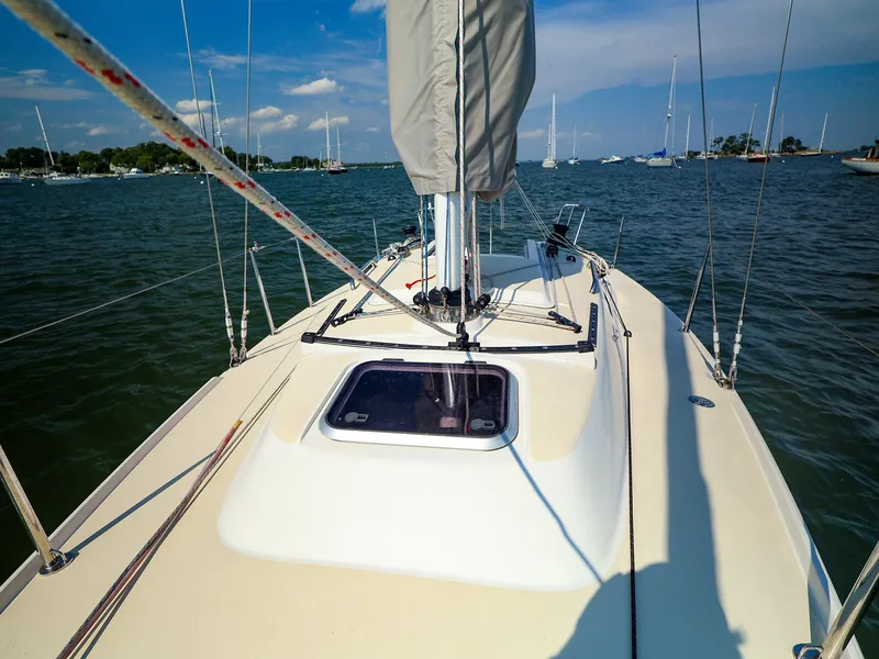 Slide: The Image of 2022 J Boats J/9 sailboat on calm water under a clear blue sky. - 6