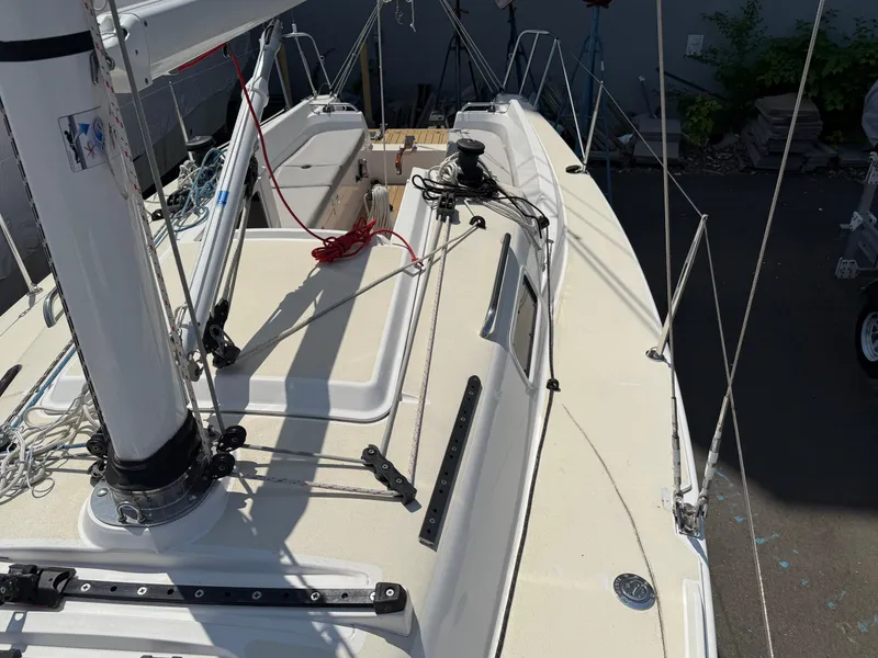 Slide: The Image of 2022 J Boats J/9 sailboat deck with rigging and mast, docked outdoors. - 8