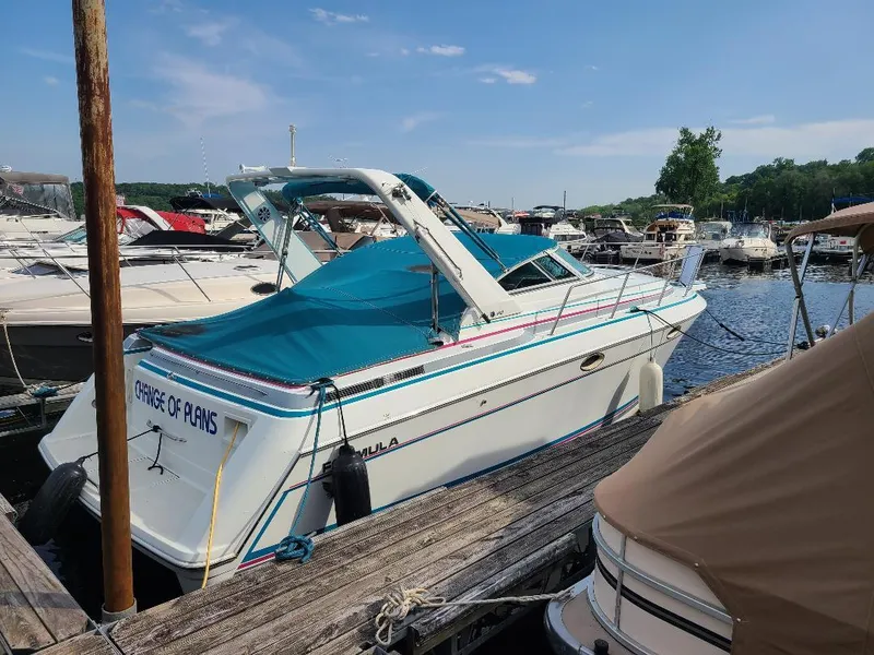 The Image of 1994 Formula 31 PC boat docked at marina, blue canopy, sunny day. - 0
