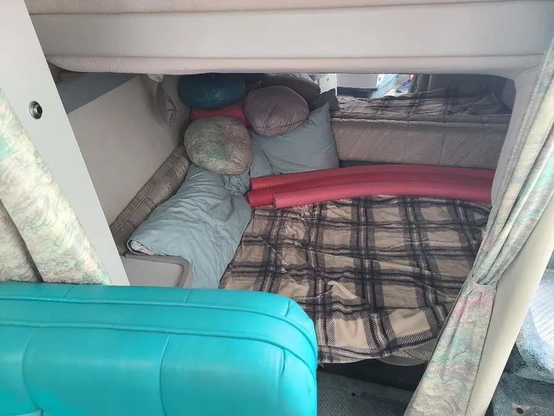 Slide: The Image of 1994 Formula 31 PC cabin interior with cozy bedding and pillows. - 11