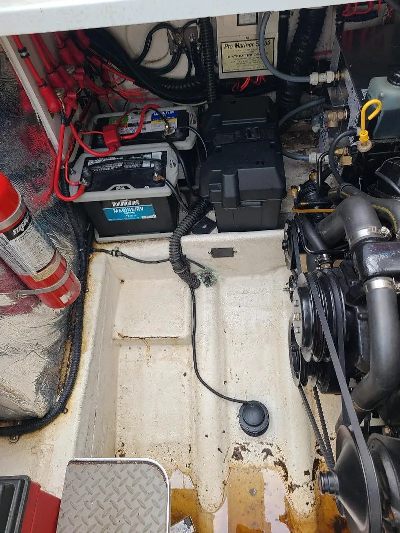 Slide: The Image of Engine compartment of a 1994 Formula 31 PC boat, showing battery and mechanical components. - 14