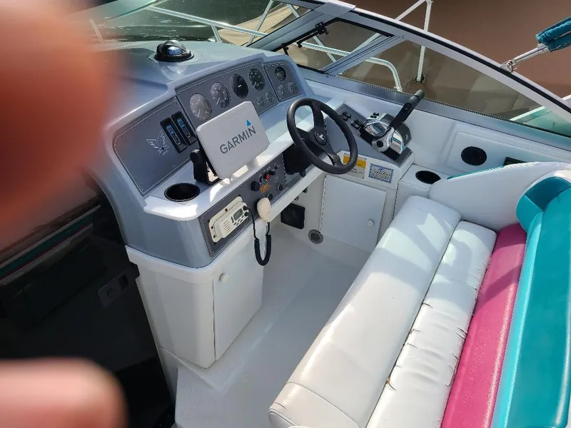 Slide: The Image of 1994 Formula 31 PC boat cockpit with Garmin navigation system and white seating. - 4