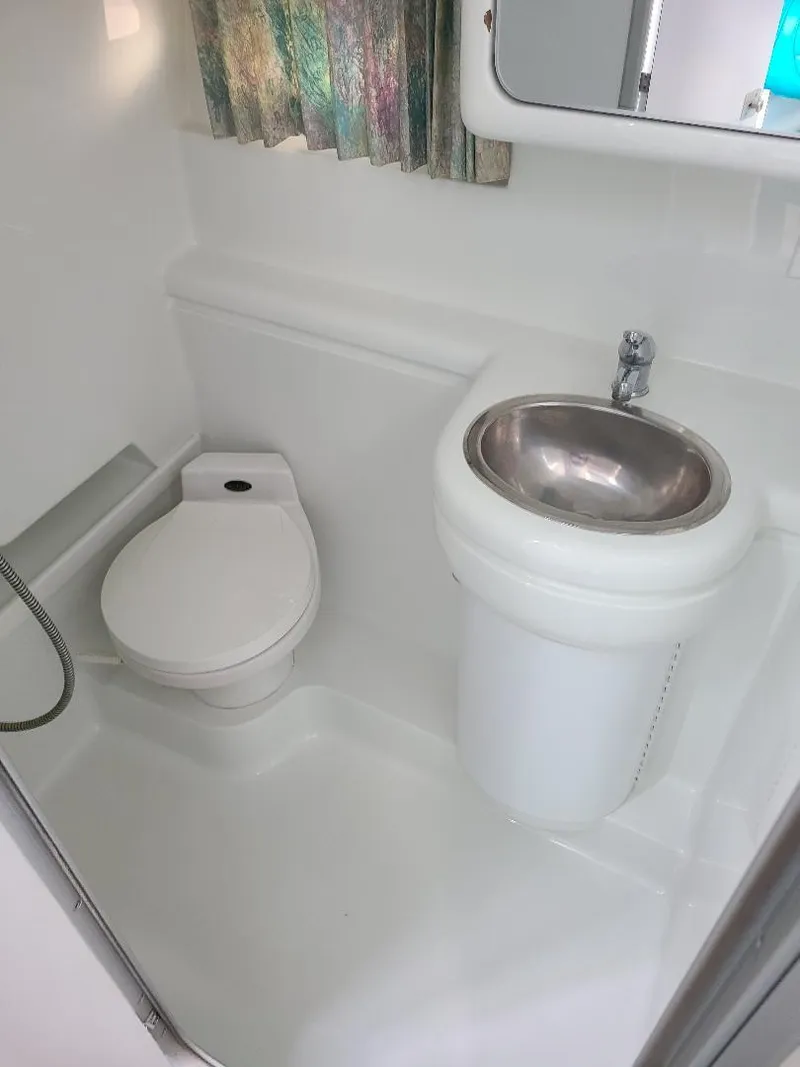 Slide: The Image of 1994 Formula 31 PC boat bathroom with toilet, sink, and shower. - 6