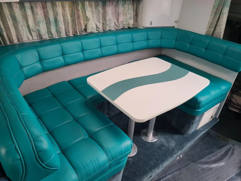 Slide: The Image of Teal upholstered seating and table in 1994 Formula 31 PC boat interior. - 8