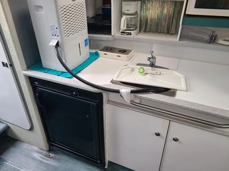 Slide: The Image of 1994 Formula 31 PC boat kitchen with sink, coffee maker, and appliances. - 9