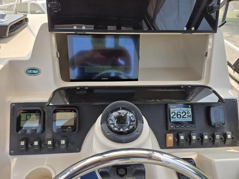Slide: The Image of Dashboard of 2007 Grady-White 232 Gulfstream boat with navigation instruments and compass. - 10