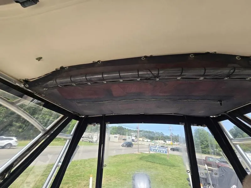 Slide: The Image of 2007 Grady-White 232 Gulfstream boat interior view with clear windows and overhead storage. - 12