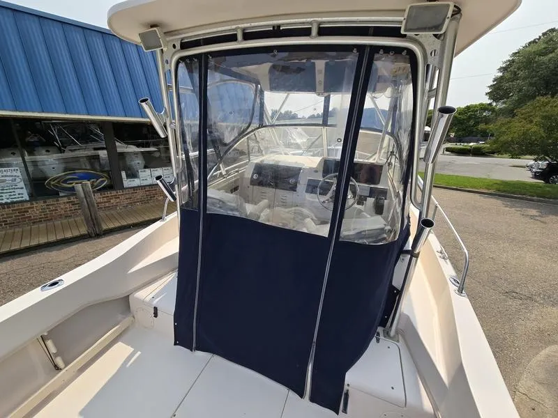 Slide: The Image of 2007 Grady-White 232 Gulfstream boat with enclosed cockpit and blue canvas cover. - 15