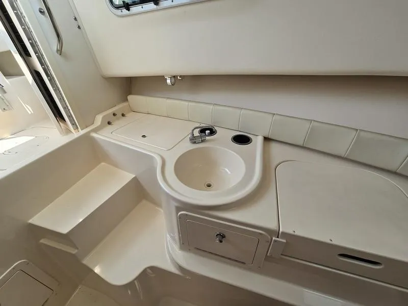 Slide: The Image of 2007 Grady-White 232 Gulfstream boat interior with sink and storage compartments. - 2