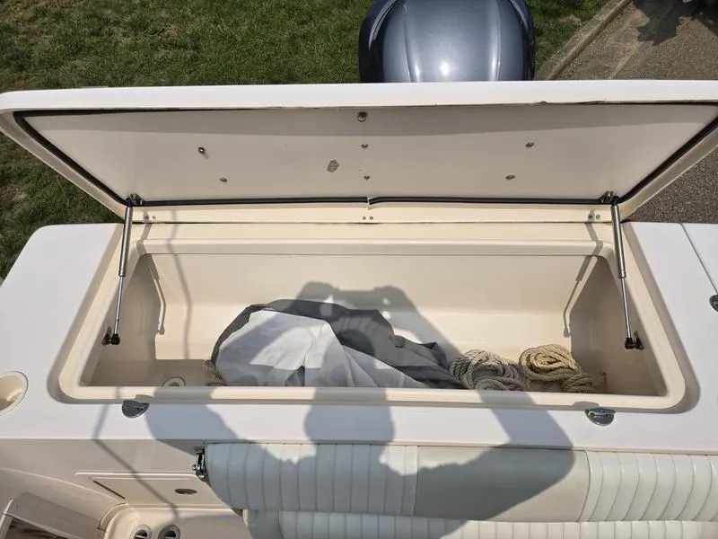 Slide: The Image of Open storage compartment on 2007 Grady-White 232 Gulfstream boat with ropes and cover. - 23