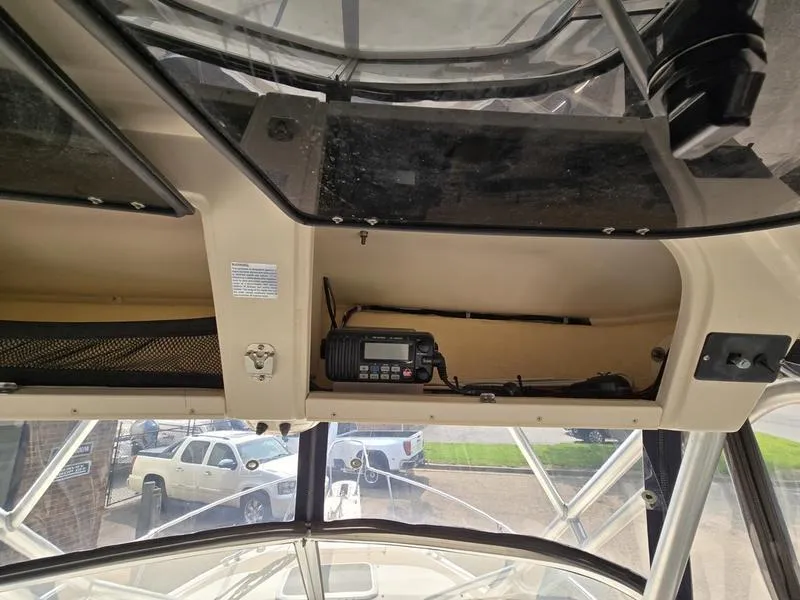 Slide: The Image of 2007 Grady-White 232 Gulfstream boat interior with radio equipment and storage compartments. - 28