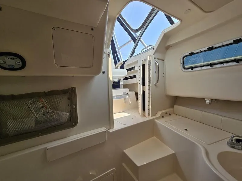 Slide: The Image of Interior of 2007 Grady-White 232 Gulfstream boat, featuring seating and storage areas. - 4
