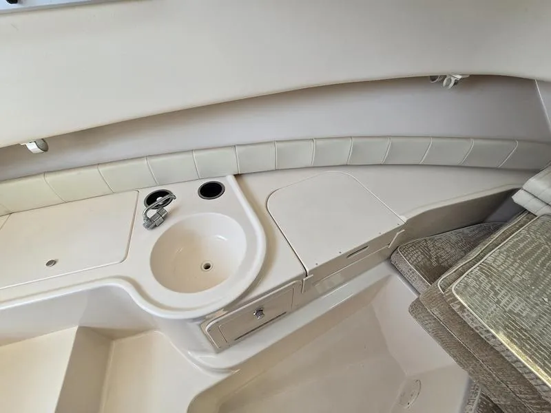 Slide: The Image of 2007 Grady-White 232 Gulfstream boat interior with sink and seating area. - 6