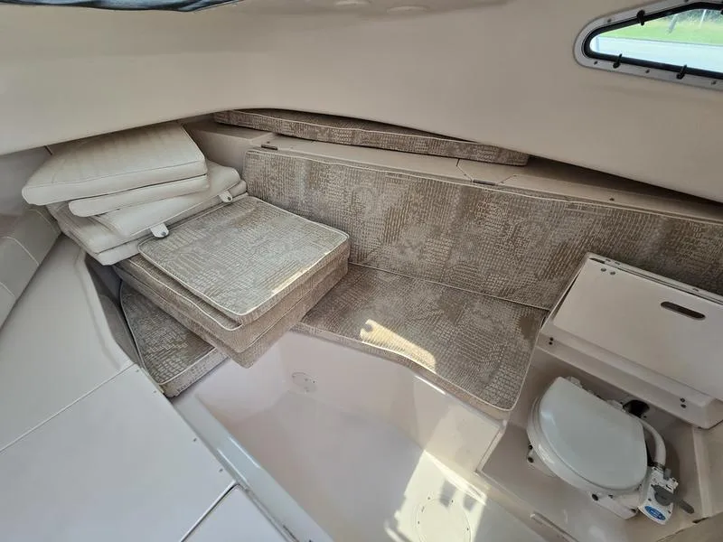 Slide: The Image of 2007 Grady-White 232 Gulfstream cabin interior with seating and compact toilet. - 7