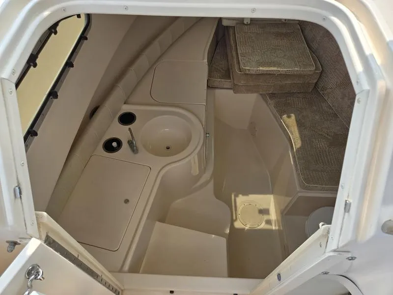 Slide: The Image of 2007 Grady-White 232 Gulfstream cabin interior with sink and seating area. - 8