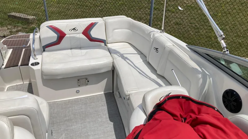 Slide: The Image of 2010 Monterey M5 Sport Boat interior with white seating and red accents. - 3