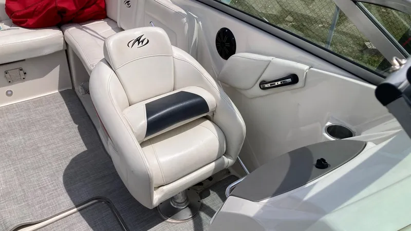 Slide: The Image of 2010 Monterey M5 Sport Boat interior with white leather seating and modern design. - 6