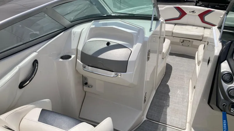 Slide: The Image of 2010 Monterey M5 Sport Boat interior with white seating and modern dashboard design. - 8