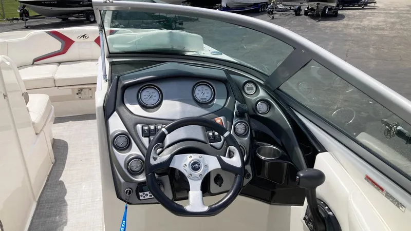Slide: The Image of 2010 Monterey M5 Sport Boat dashboard with steering wheel and gauges. - 9