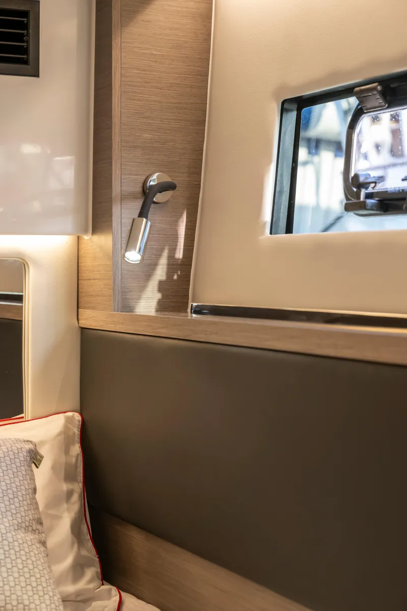 Slide: The Image of Interior of 2026 Jeanneau NC1295 Coupe, featuring modern design and cozy lighting. - 18