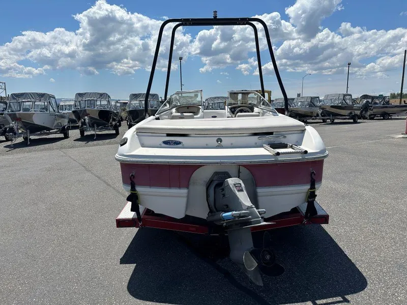 Slide: The Image of 2003 Chaparral 180 SS boat in a parking lot under a cloudy sky. - 3